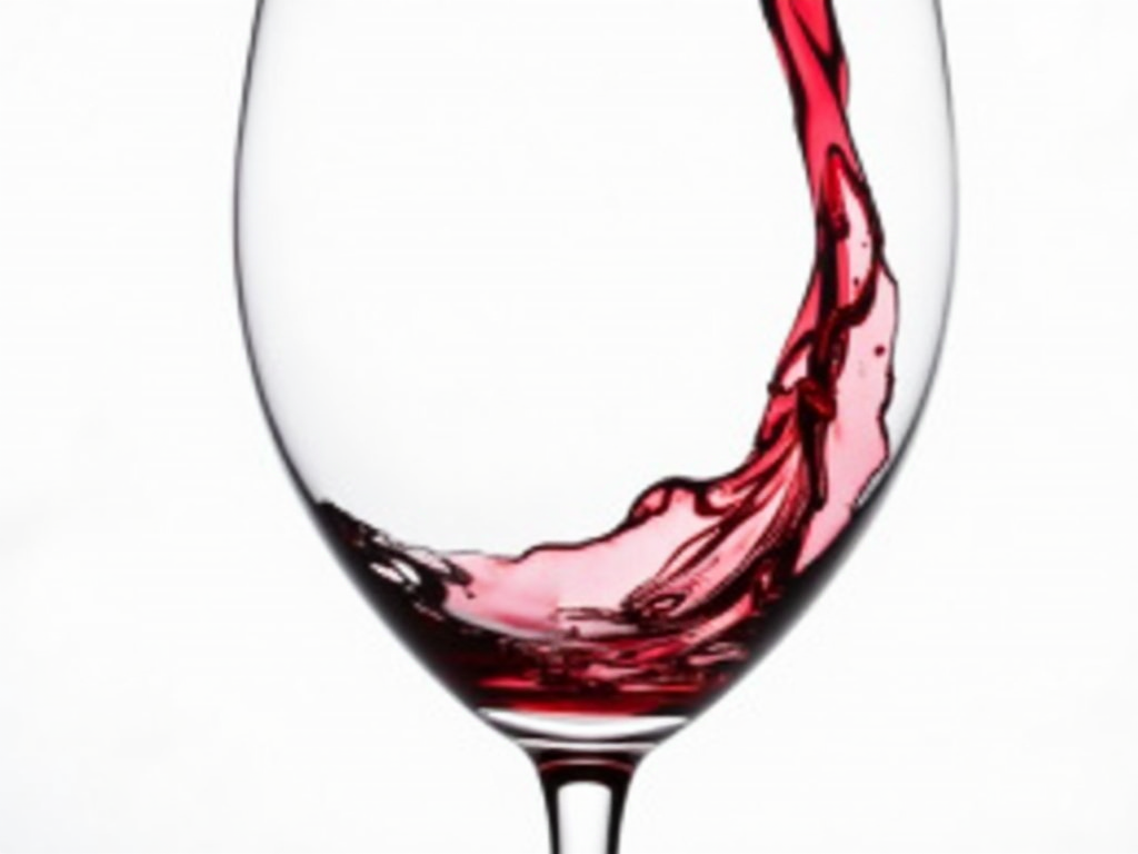 Wine glass being swirled to observe color and legs