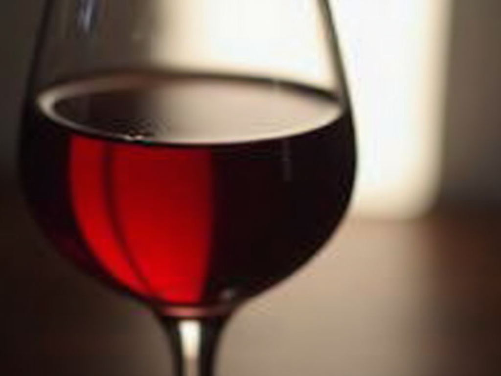 Red wine in a glass, showcasing its deep ruby color.