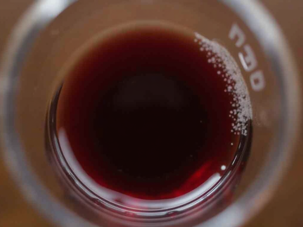 A glass of Beringer Merlot wine.