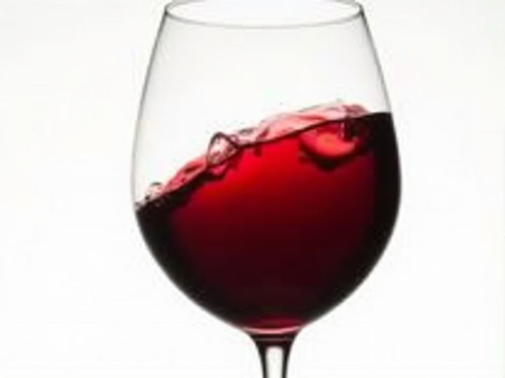 A glass of red wine displaying its vibrant color and clarity.