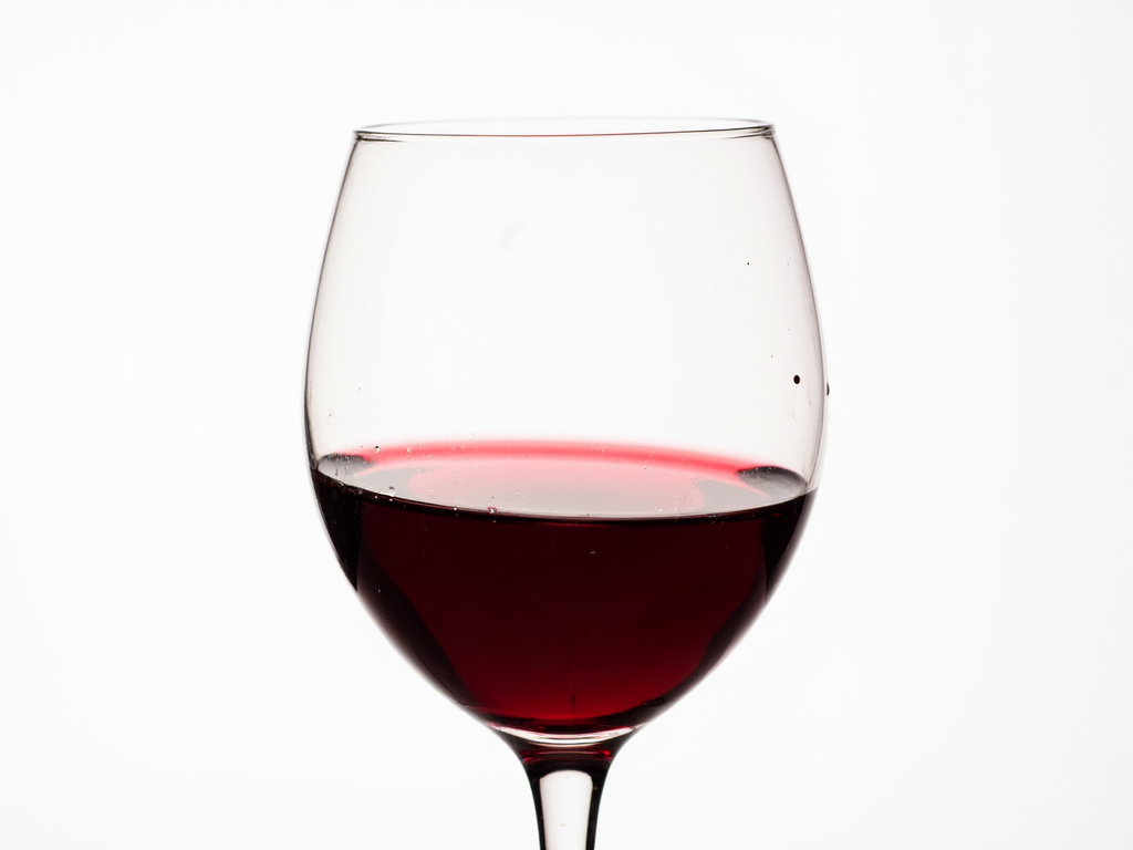 A glass of red wine showing its rich color and clarity.